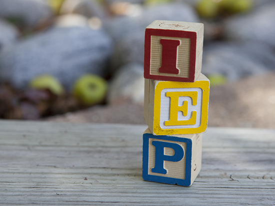 Child blocks spelling out IEP