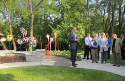 Man speaking to crowd at opening of the healing garden