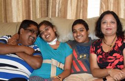 Saurabh Agarwal smiling and seated with his daughter, Radhika; son, Ayush; and wife, Mukta.