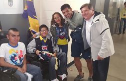 Brothers with muscular dystrophy pose with members of the Club America soccer team and their mother.