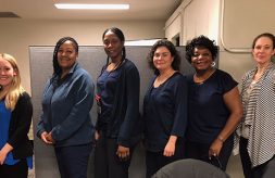 Five Chicago Public Health Department nurses and a hearing screening trainer pose together.