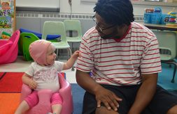 Deaf infant plays with an instructor during the 2018 Institute for Parents of Preschool Children who are Deaf or Hard of Hearing