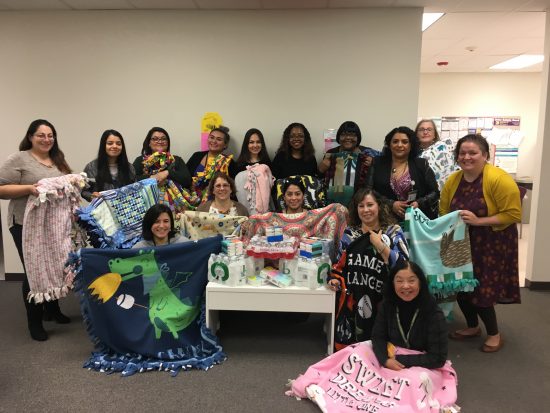 DSCC's Lombard RO staff poses with blankets they made for caregivers