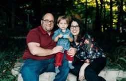 DSCC participant Jakob Kojro-Badziak smiling and posing with his parents, Jason and Jennifer