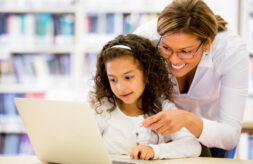 Mother and daughter looking at a laptop computer