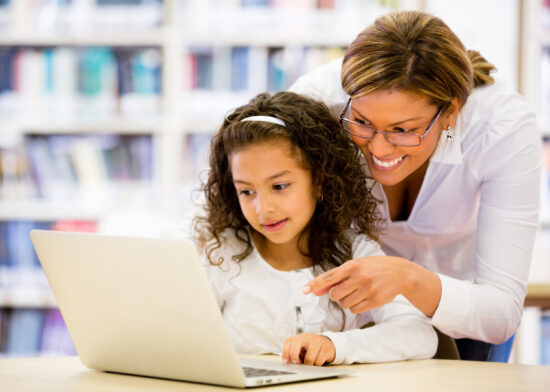 Mother and daughter looking at a laptop computer