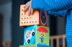 close-up of a child's hands stacking large blocks