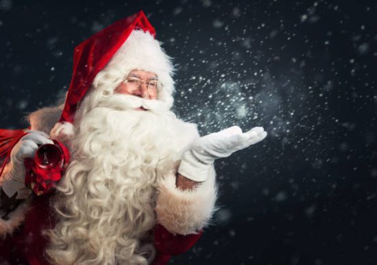 Santa with his bag and blowing magic snow out of his hand