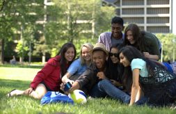 group of students taking a selfie in a grassy area of the UiC campus